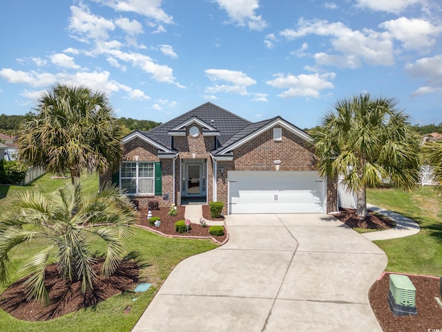 2940 Tigers Eye Rd, Little River, SC 29566 - traditional-style house with brick siding, concrete driveway, a front yard, and a garage