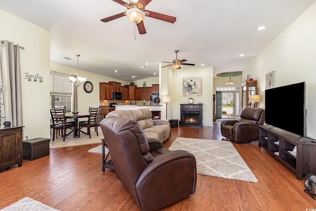 2940 Tigers Eye Rd, Little River, SC 29566 - living room featuring ceiling fan, wood finished floors, a warm lit fireplace, recessed lighting, and lofted ceiling