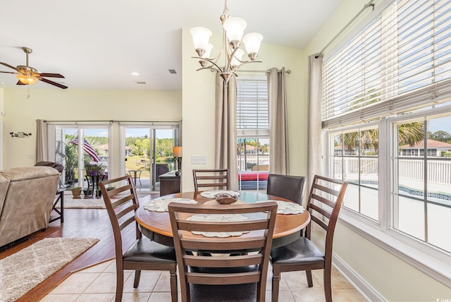 2940 Tigers Eye Rd, Little River, SC 29566 - dining space with plenty of natural light, a chandelier, vaulted ceiling, a ceiling fan, and light tile patterned floors