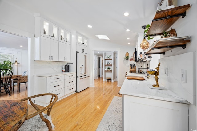 kitchen featuring high end fridge, open shelves, white cabinets, light wood-type flooring, and recessed lighting