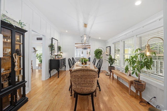 dining space with crown molding, recessed lighting, plenty of natural light, and light wood-style floors