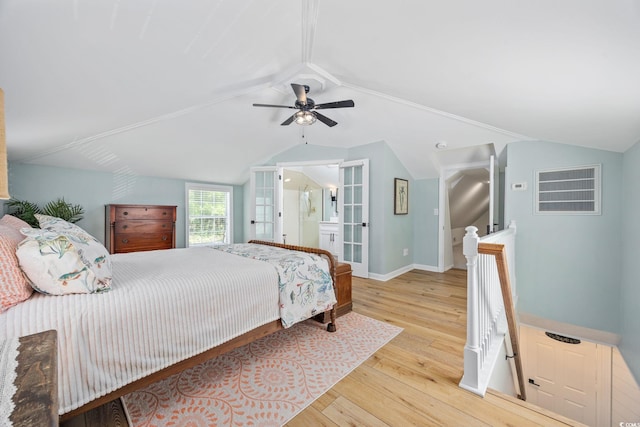 bedroom with lofted ceiling, baseboards, hardwood / wood-style floors, and a ceiling fan