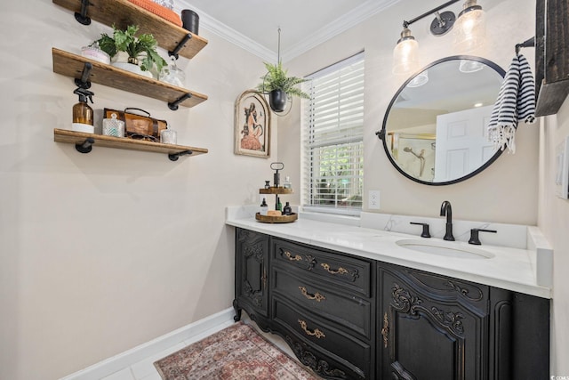 bathroom featuring baseboards, vanity, and crown molding