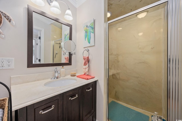 full bathroom with a marble finish shower, vanity, and ornamental molding