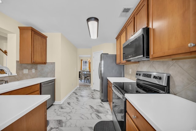 381 Winslow Ave, Myrtle Beach, SC 29588 - kitchen featuring visible vents, marble finish floor, brown cabinets, a sink, and appliances with stainless steel finishes