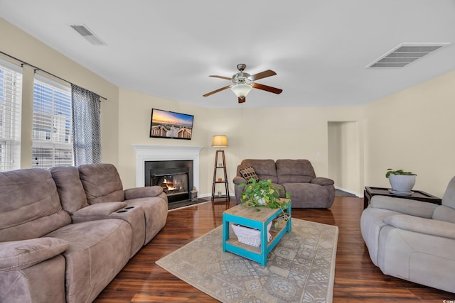 381 Winslow Ave, Myrtle Beach, SC 29588 - living room featuring visible vents, a glass covered fireplace, ceiling fan, and dark wood-style floors
