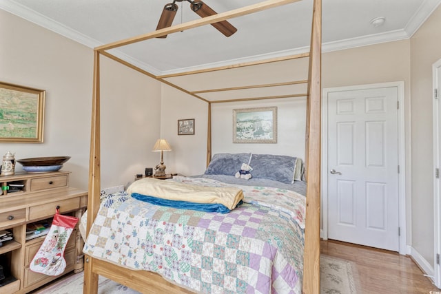 bedroom featuring crown molding, a ceiling fan, and light wood-type flooring