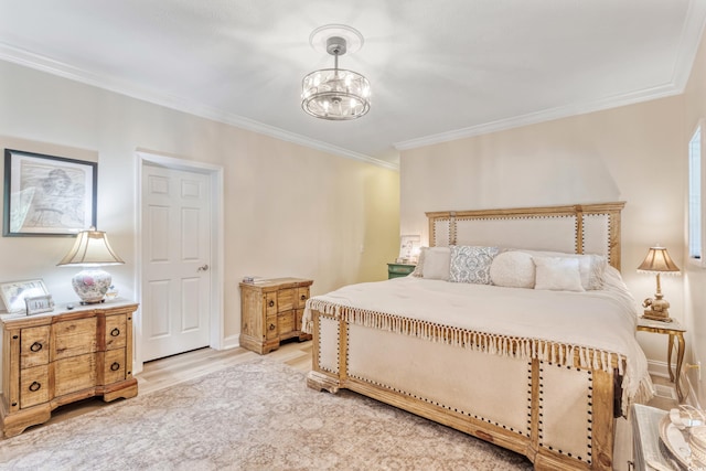 bedroom with light wood-style floors, ornamental molding, and a chandelier
