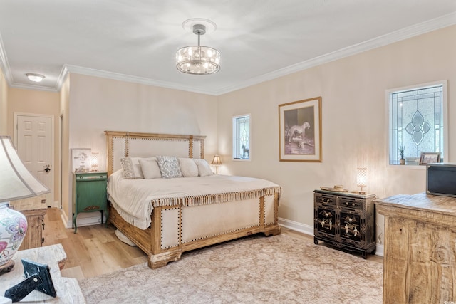 bedroom featuring crown molding, baseboards, wood finished floors, and a chandelier