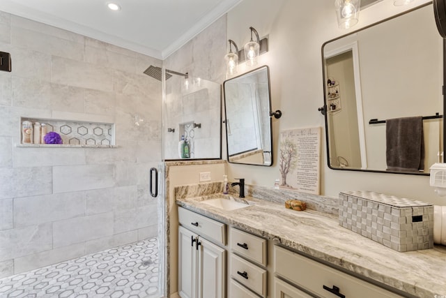 full bathroom with a shower stall, ornamental molding, and vanity