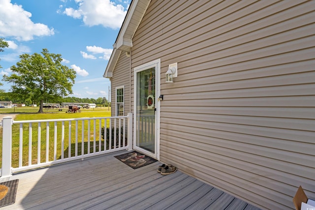 wooden deck featuring a yard