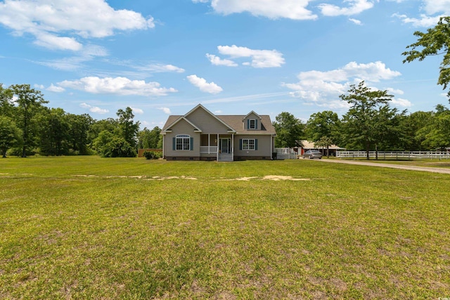 view of front of house with a porch, fence, a front yard, and crawl space