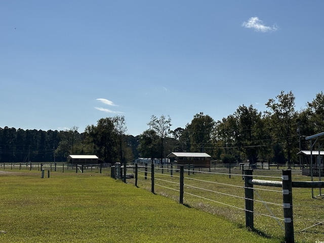 view of yard featuring fence and a rural view