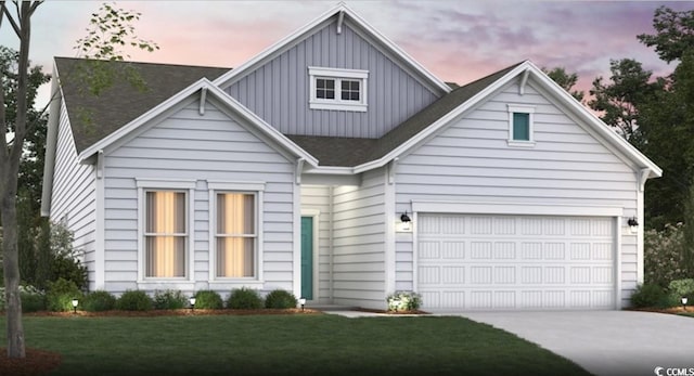 view of front of house with board and batten siding, concrete driveway, a shingled roof, a yard, and an attached garage