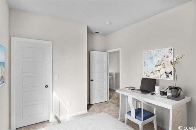home office featuring baseboards and light carpet