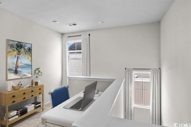 carpeted office space featuring visible vents
