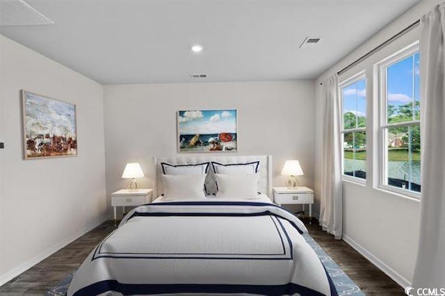 bedroom featuring recessed lighting, baseboards, dark wood finished floors, and visible vents