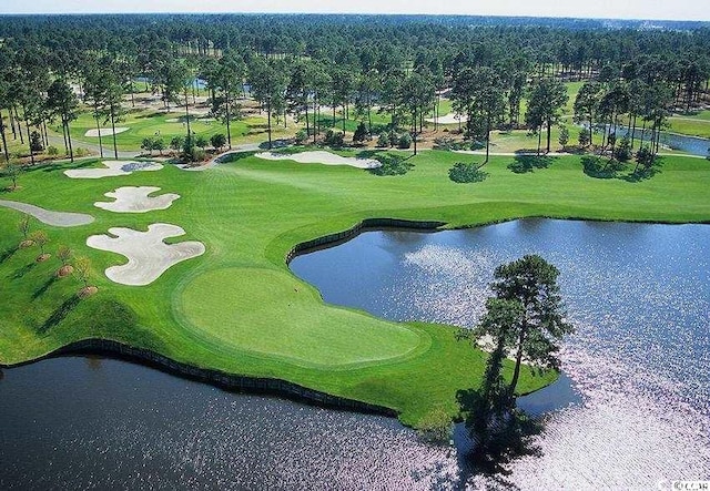 birds eye view of property with a water view and golf course view