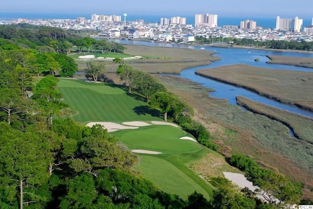 aerial view with a water view, view of golf course, and a city view