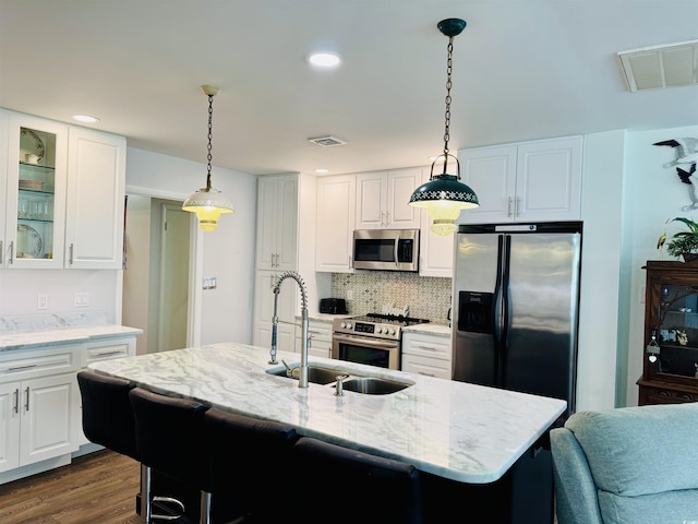 801 Talbot Cir, Myrtle Beach, SC 29577 - kitchen featuring stainless steel appliances, light stone counters, glass insert cabinets, decorative backsplash, and a sink