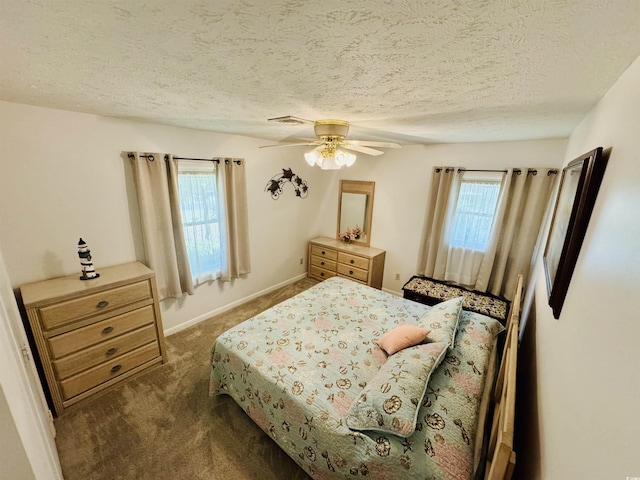 801 Talbot Cir, Myrtle Beach, SC 29577 - carpeted bedroom featuring multiple windows, a textured ceiling, a ceiling fan, and baseboards