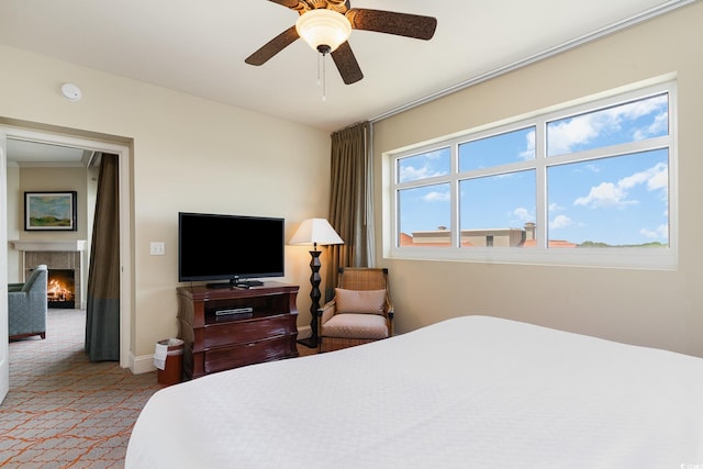 8121 Amalfi Pl Unit 4-801, Myrtle Beach, SC 29572 - carpeted bedroom with a tile fireplace and ceiling fan