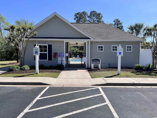 109 Old Town Way Unit 4, Myrtle Beach, SC 29588 - view of front of property with fence, roof with shingles, ceiling fan, a gate, and uncovered parking