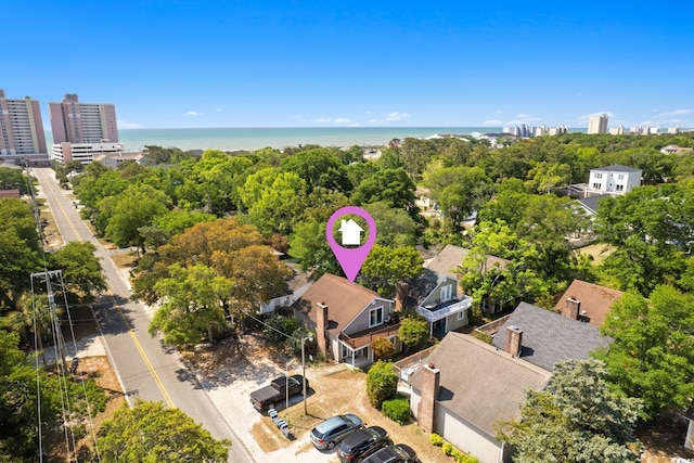 birds eye view of property with a view of city and a water view