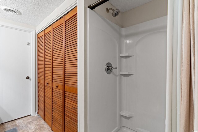 607A 28th Ave S, North Myrtle Beach, SC 29582 - full bathroom featuring a textured ceiling, a shower with shower curtain, and stone finish flooring