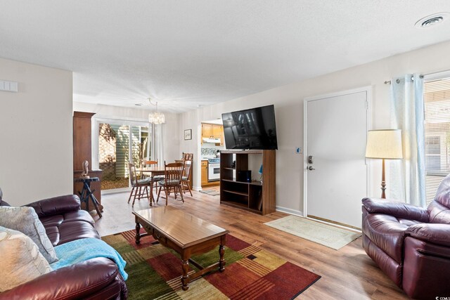 607A 28th Ave S, North Myrtle Beach, SC 29582 - living area with a chandelier, light wood-style flooring, and baseboards
