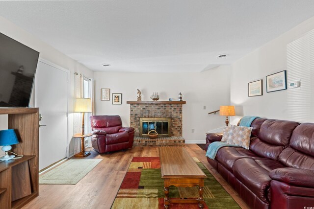 607A 28th Ave S, North Myrtle Beach, SC 29582 - living area with a brick fireplace, wood finished floors, and baseboards