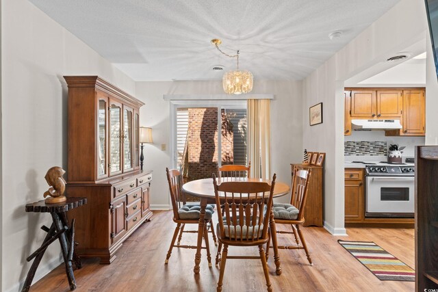 607A 28th Ave S, North Myrtle Beach, SC 29582 - dining room with a chandelier, light wood finished floors, and baseboards