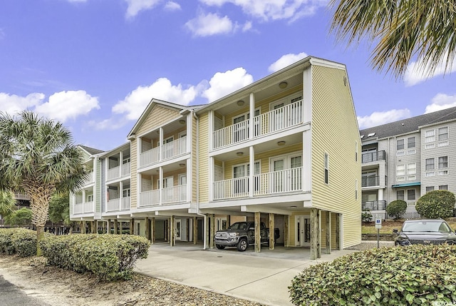 209 Hillside Dr N Unit 104, North Myrtle Beach, SC 29582 - view of property featuring a carport and driveway
