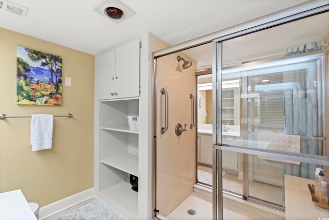 bathroom with visible vents, baseboards, and a stall shower