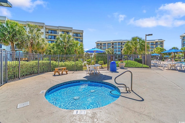 view of swimming pool featuring a patio area, fence, and a pool