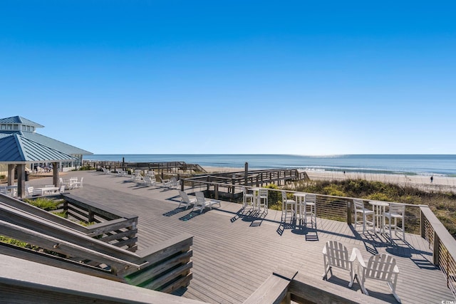 deck featuring a gazebo, a view of the beach, and a water view