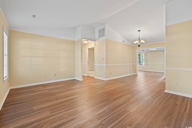 spare room featuring baseboards, visible vents, a chandelier, and light wood-type flooring