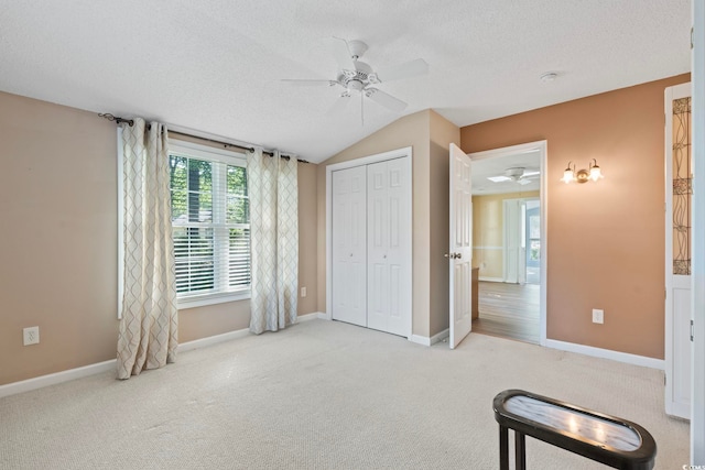 88 Purple Martin Dr, Murrells Inlet, SC 29576 - unfurnished bedroom featuring a textured ceiling, carpet, vaulted ceiling, ceiling fan, and a closet