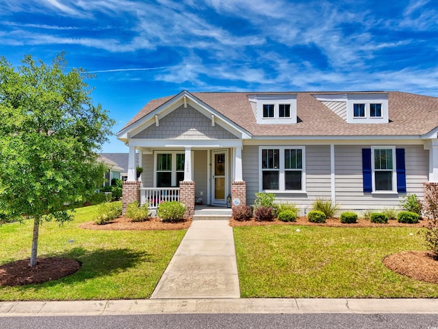 1048 Longwood Bluffs Cir, Murrells Inlet, SC 29576 - view of front of home with covered porch, a front yard, and a shingled roof