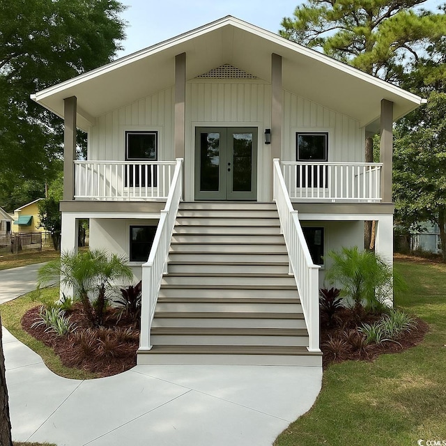 view of front facade with a porch, french doors, and stairway