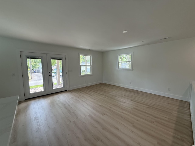 interior space featuring french doors, recessed lighting, baseboards, and light wood-type flooring