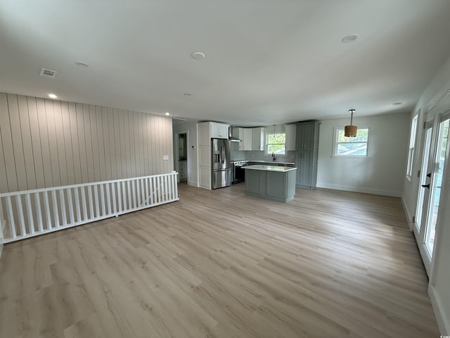 unfurnished living room featuring recessed lighting, baseboards, light wood finished floors, and visible vents