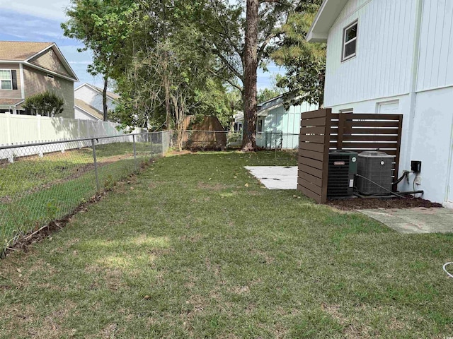 view of yard with a fenced backyard and central air condition unit