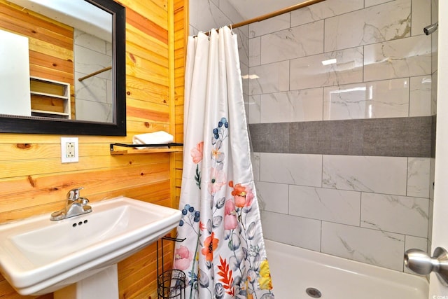 bathroom featuring a stall shower and a sink