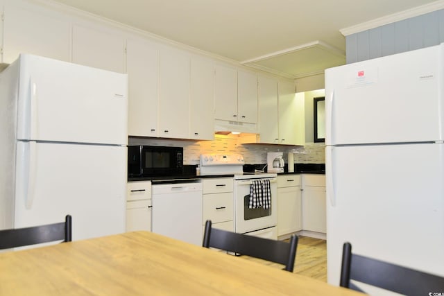 kitchen featuring under cabinet range hood, ornamental molding, white appliances, decorative backsplash, and light wood-style floors