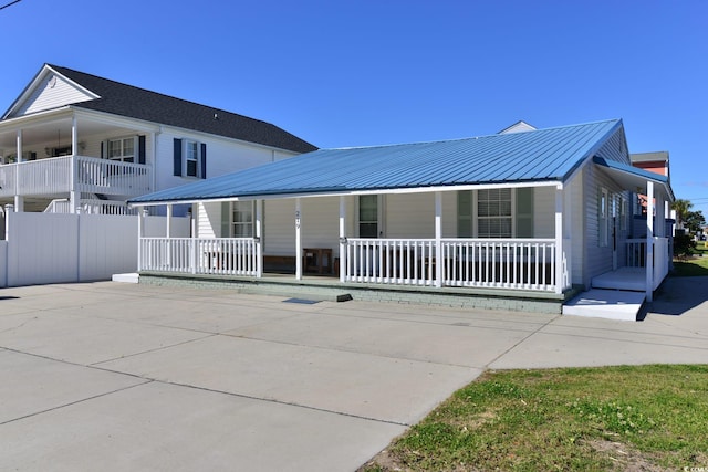 view of front of property with a porch and metal roof