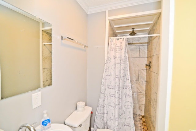 full bathroom with toilet, tiled shower, and a sink