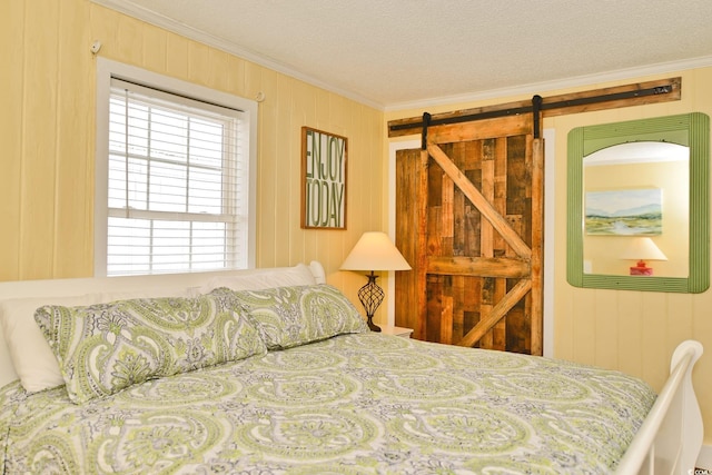 bedroom with ornamental molding and a textured ceiling