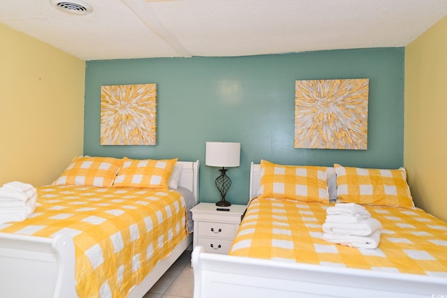 tiled bedroom with visible vents