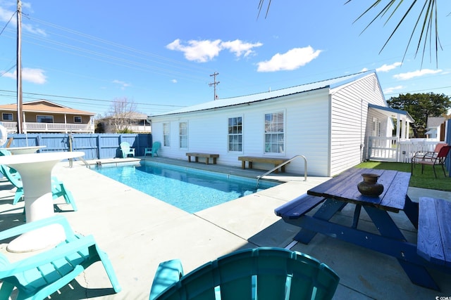 view of pool featuring a fenced backyard, a patio, a fenced in pool, and a hot tub
